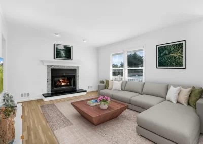 Cozy living room featuring a fireplace and sectional sofa, highlighted by professional virtual staging design.