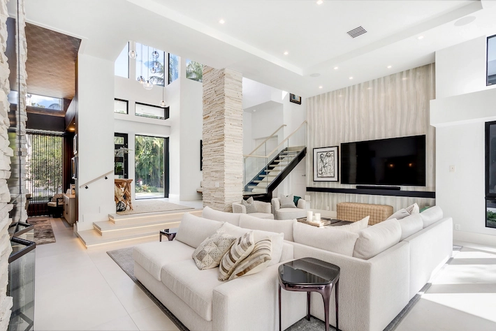 Bright, color-corrected bedroom featuring manual HDR blending and clear window views.