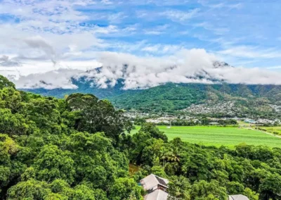 Enhanced drone shot of a mountain property with a vibrant, clear sky after professional editing.