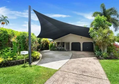 A suburban home driveway featuring a professional sky replacement edit to improve listing curb appeal.